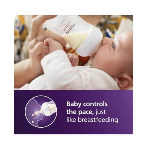 Bottle-feeding baby with milk, showcasing baby care and nurturing.
