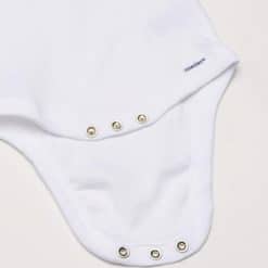 White baby onesie with snap buttons, soft cotton fabric, and Onesies® label for comfortable infant wear.