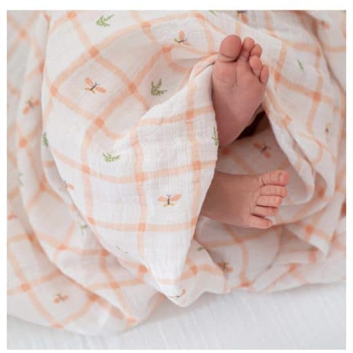 Soft baby blanket with orange checkered pattern and small butterfly details, partially covering tiny baby feet. Perfect for newborns, providing comfort and warmth in Stamford.