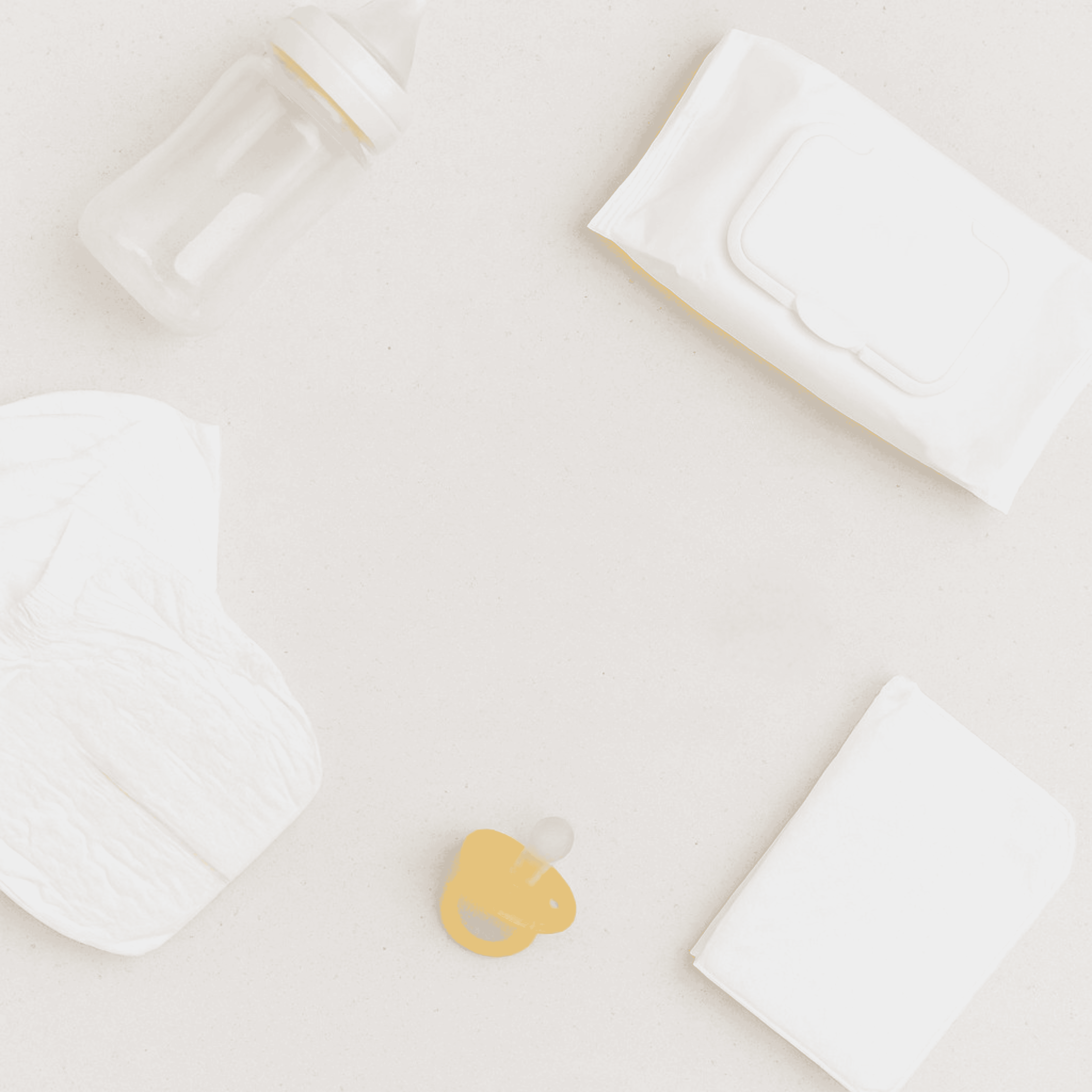 Soft baby essentials including diapers, wipes, and a pacifier arranged on a white surface for newborn care.