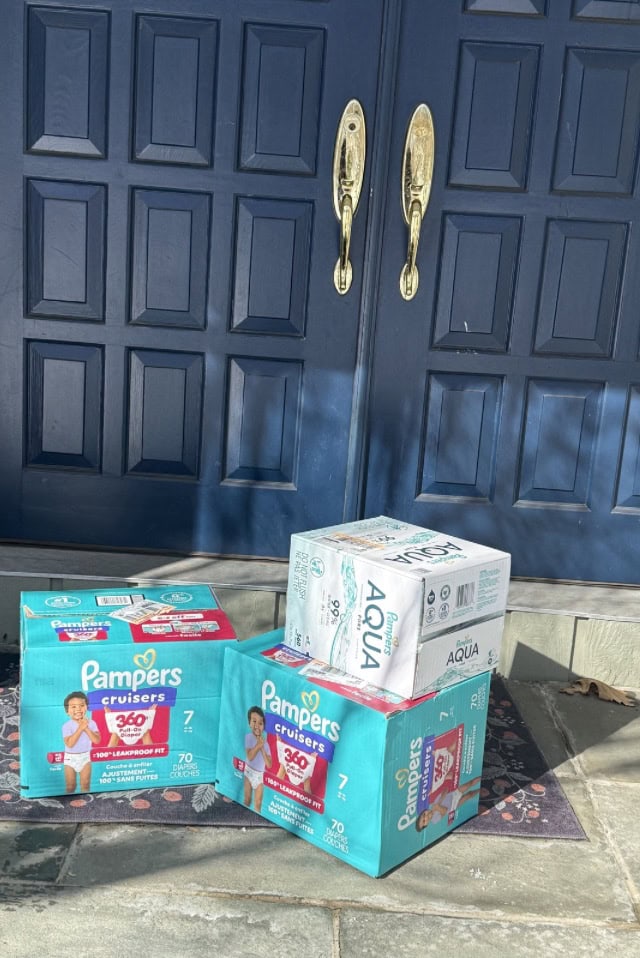 Sealed baby essentials delivery photographed at a Greenwich door in the daytime